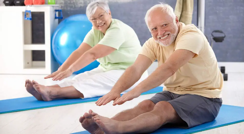 Photo of older couple stretching with improved mobility